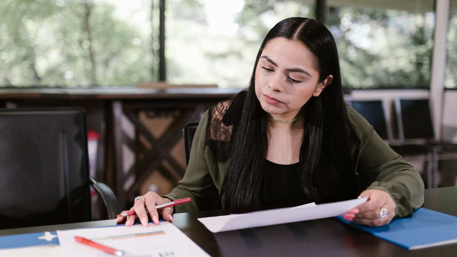 A care manager reviewing documents at a desk