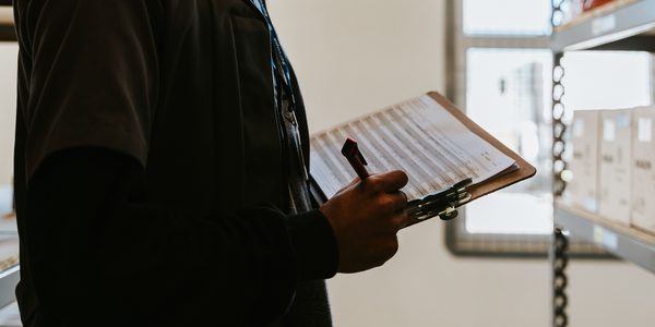 Professional reviewing a clipboard checklist for inspection readiness